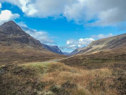 Clouds above the mountains and green valley of Glencoe, Scotland
